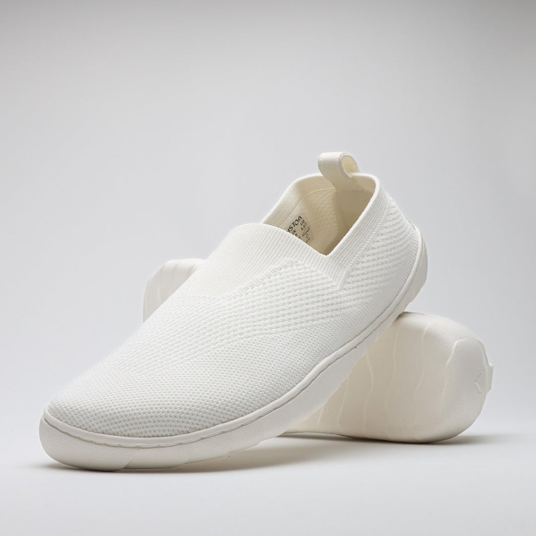 White Vaistoa Lempeä 3 slip-on barefoot shoes shown as a pair in angled view with outsole visible