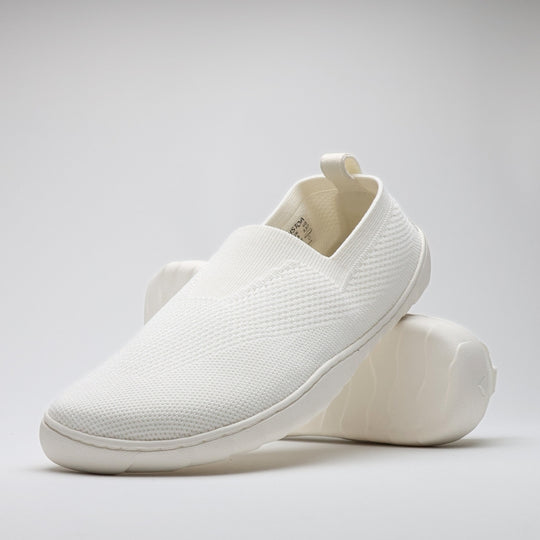 White Vaistoa Lempeä 3 slip-on barefoot shoes shown as a pair in angled view with outsole visible