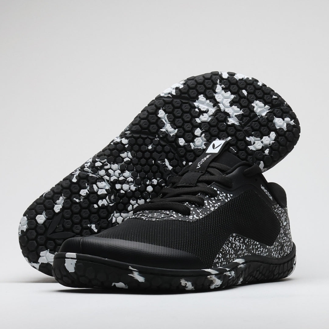 Vaistoa Lento barefoot running shoes – black and white shoe in a studio image with the outsole visible behind it against a light background