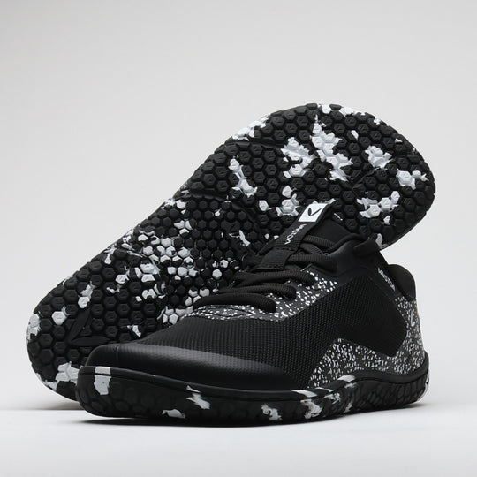 Vaistoa Lento barefoot running shoes – black and white shoe in a studio image with the outsole visible behind it against a light background