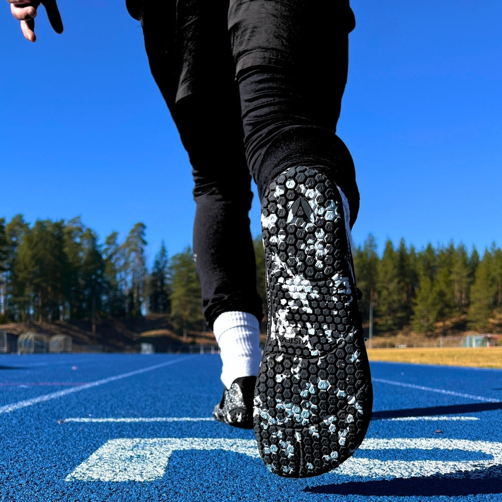 Vaistoa Lento barefoot running shoes – outsole visible while stepping on a running track