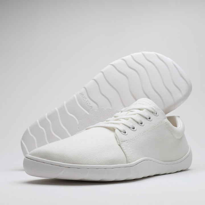 Vaistoa Rento 2 barefoot shoes, low-cut canvas sneakers – white shoe with outsole shown behind at an angle against a white background