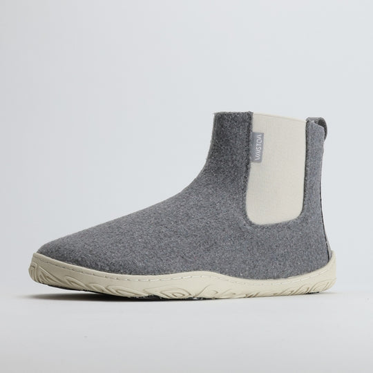 Single pearl grey barefoot winter felt Chelsea boot shown from a front angle on a light gray background, highlighting its warm felt material and sleek, natural design.