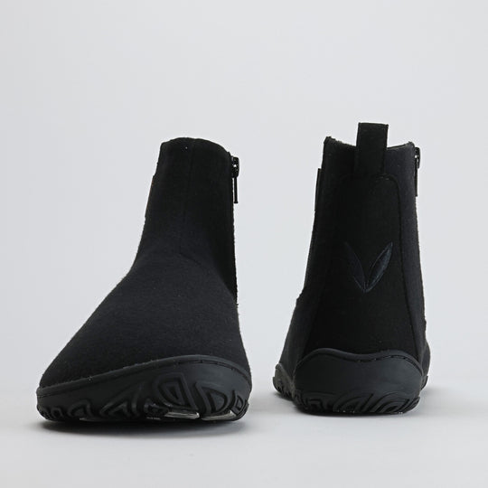Pair of velvet black barefoot winter felt Chelsea boots shown from the front and back on a light gray background, highlighting their minimalist silhouette and balanced design.