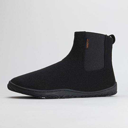 Single velvet black barefoot winter felt Chelsea boot shown from a front angle on a light gray background, highlighting its sleek shape and minimalist Nordic design.