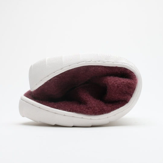 Vaistoa Toive felt barefoot slippers – burgundy felt slipper folded in half to show the thin and flexible outsole