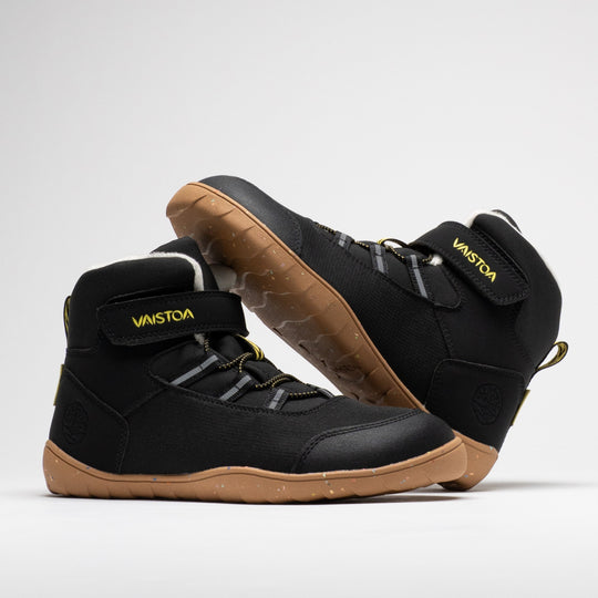 Vaistoa Ulappa 2 kids waterproof barefoot sneakers – pair with one shoe leaning horizontally against the shaft of the standing shoe, showing its outer side and the edge of the outsole