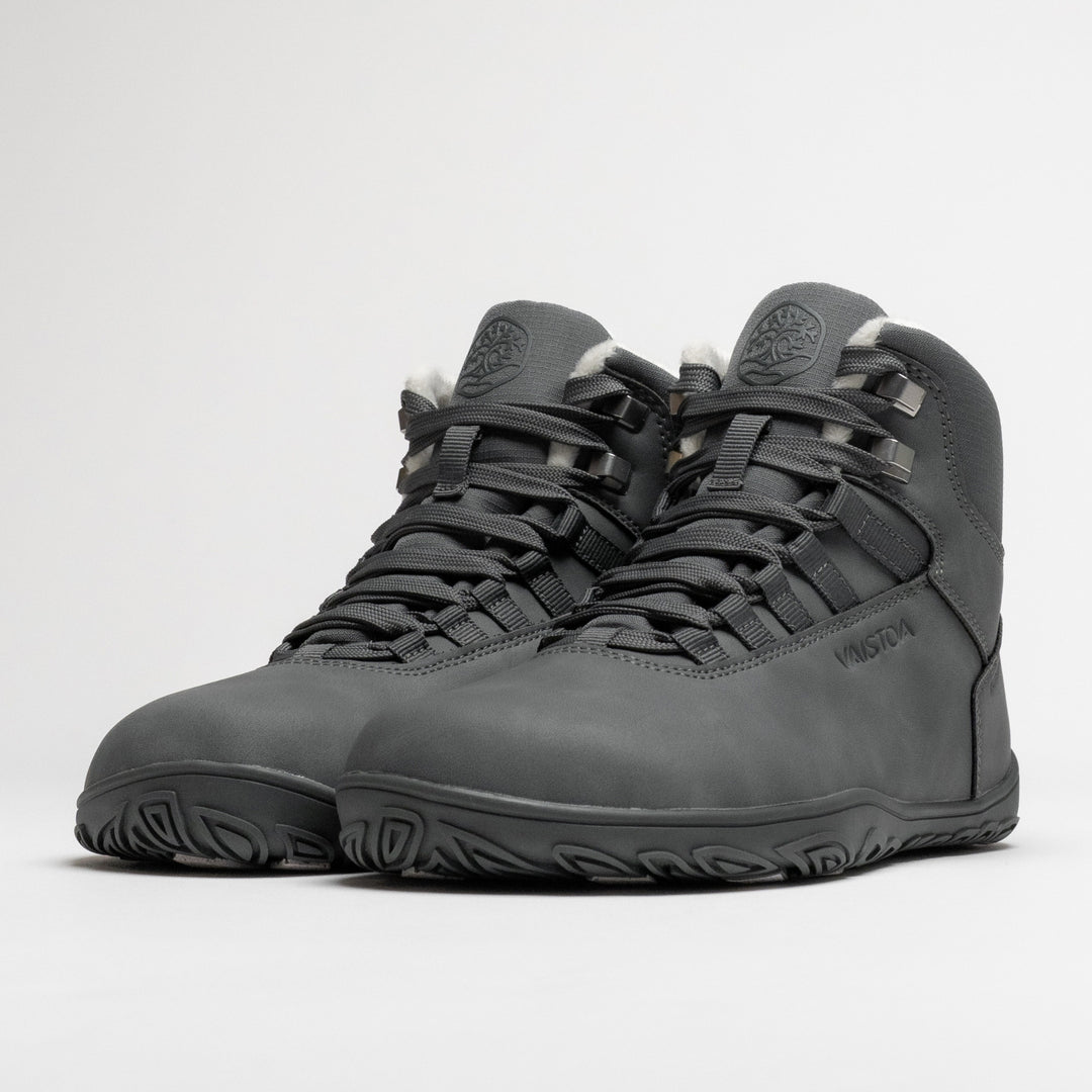 Vaistoa Uoma 4 winter barefoot trekking boots – pair shown from a front angle with the lacing and metal lace hooks visible