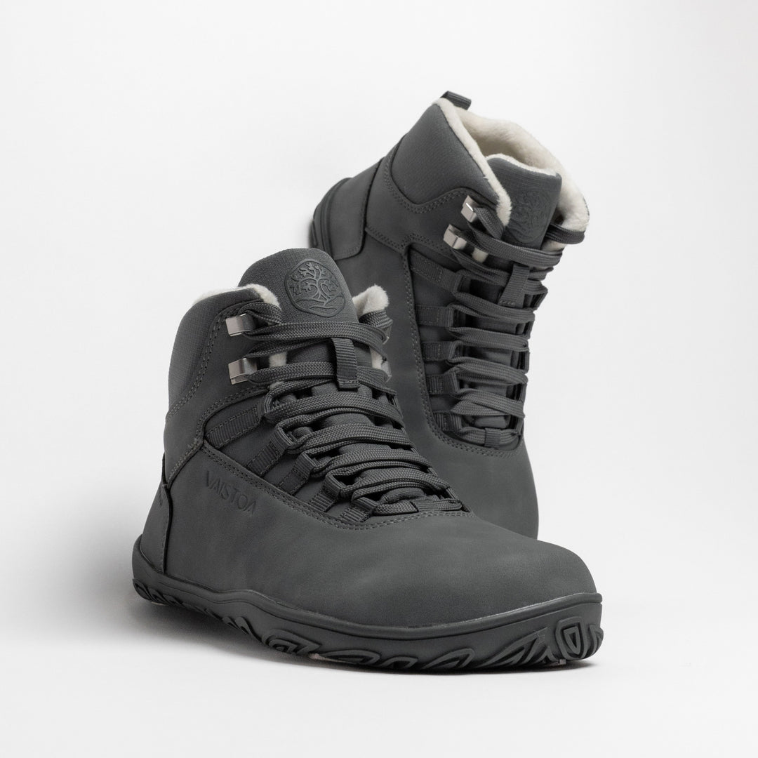 Vaistoa Uoma 4 winter barefoot trekking boots – pair shown from a front angle with one shoe in front of the other and the faux fur lining visible at the collar