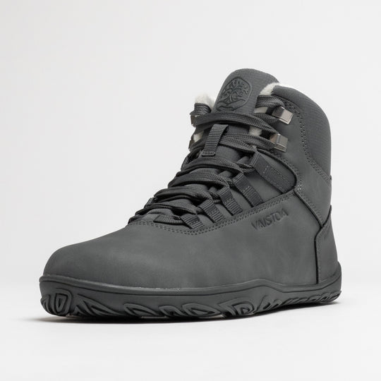 Vaistoa Uoma 4 winter barefoot trekking boots – single shoe shown from a front angle with the lacing and the Vaistoa logo on the side visible