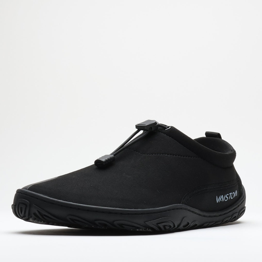 Black Vaistoa Vire barefoot shoe shown from the side profile against a light background. The low-profile design, flexible upper, and thin outsole are clearly visible.
